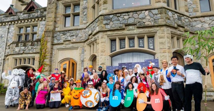RRU community dressed up in their Halloween costumes in front of Hatley Castle.