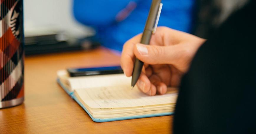 Student writing in notebook