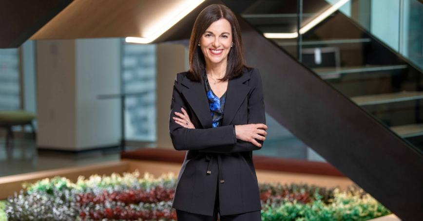 Veni Iozzo smiling and standing with her arms crossed.