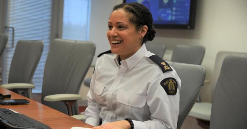 Veronica Fox smiling in a board room wearing an RCMP uniform