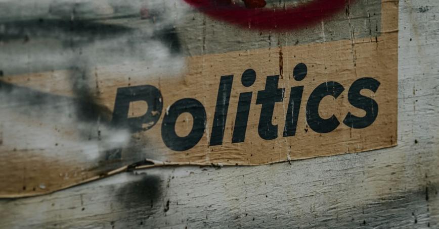 Concrete wall with the word politics written on it.
