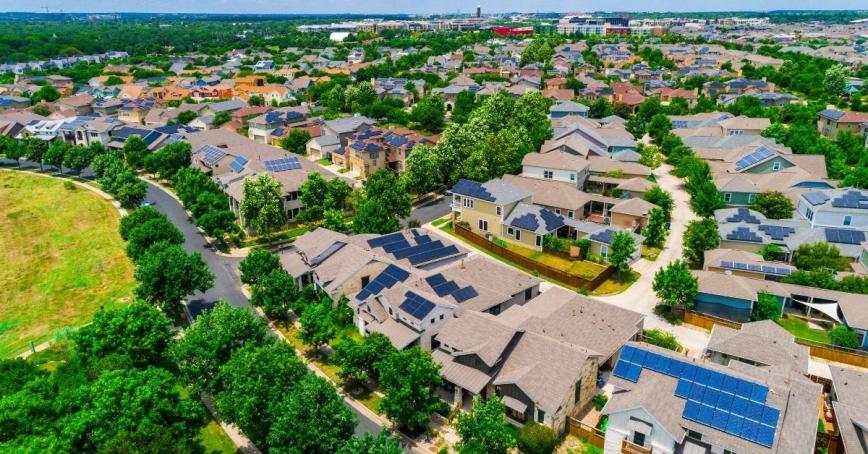 A community of houses with solar panels on the rooves.