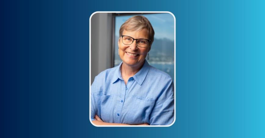 Lori Wanamaker smiling in front of a neutral background