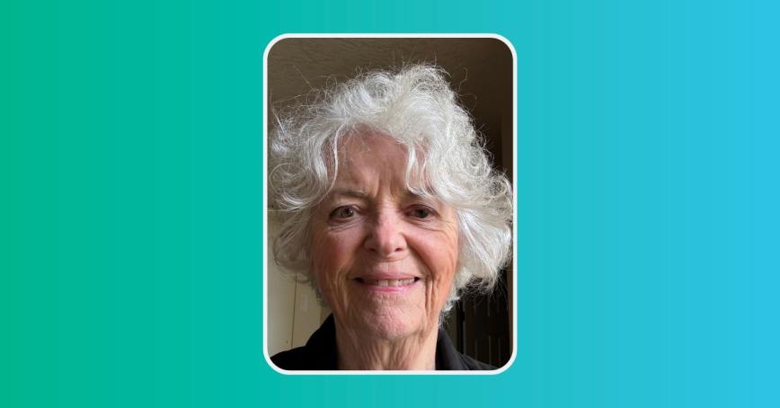 Head shot of Ann Perodeau smiling with a green and blue background