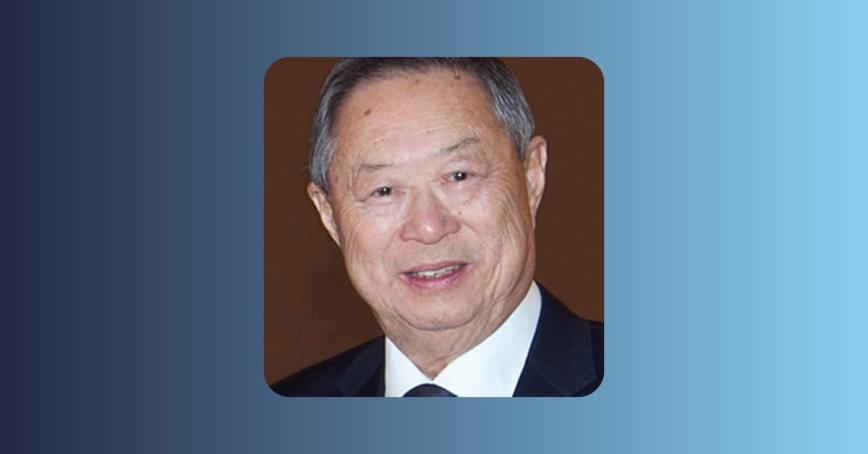 Stanley Kwok head shot on a background of blue and grey gradient