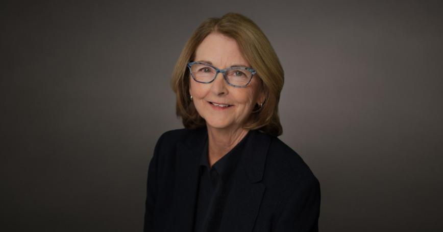 Deb Linehan smiling in front of a neutral background