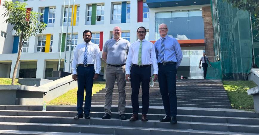 Four men stand on the steps of a building at the Sri Lanka Institute for Information Technology