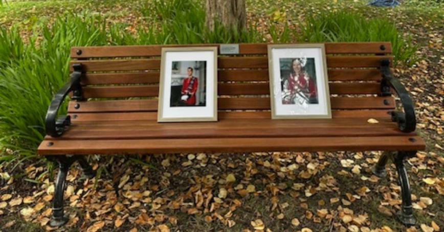 Memorial Bench with framed photos of Captain Miles Selby and Captain Juli-Ann Mackenzie