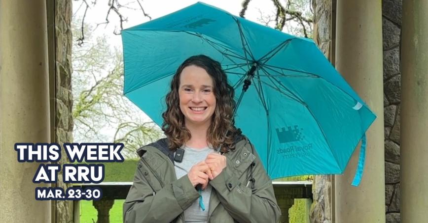 Smiling woman holding a blue umbrella 