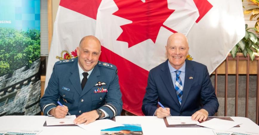 Major-General Jeannot Boucher, Commander of the Canadian Defence Academy, and Dr. Philip Steenkamp, President and Vice-Chancellor of Royal Roads University, sign an agreement during a ceremony in Kingston, Ontario, on April 24, 2026. Photo by: Corporal Brandon Liddy