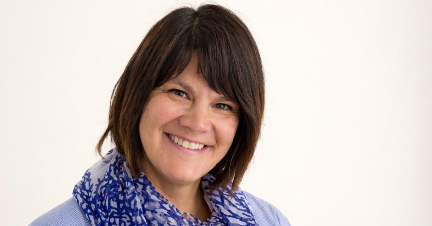 Kelly Terbasket smiling in front of a white background