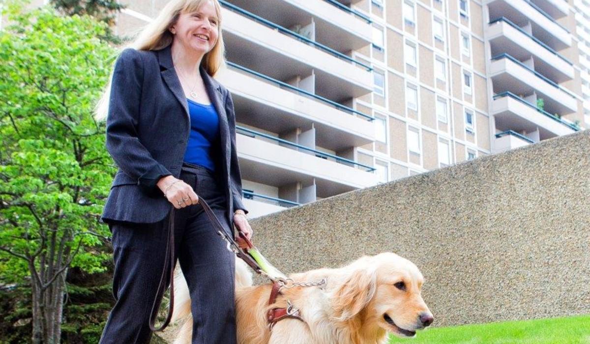 Diane Bergeron walks her dog outdoors