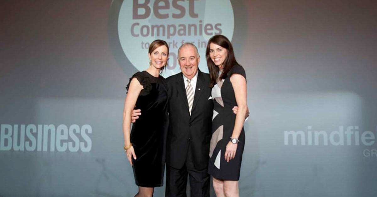 The Legge family standing for a photo in front of a backdrop