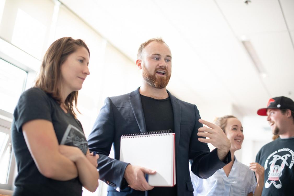 four-students-talking-at-poster-presentations