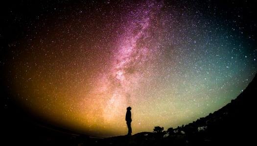 Person looking up at the night sky