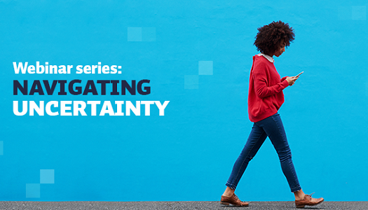Person walking and looking at their phone, with the text on the picture saying Webinar series: Navigating uncertainty.