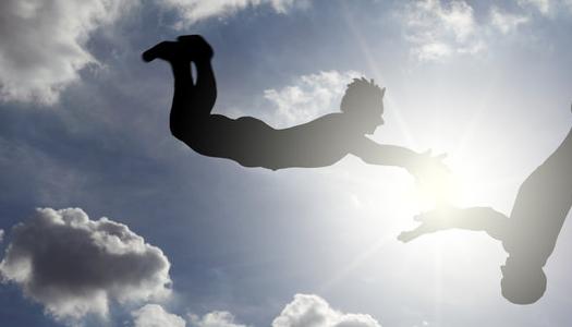 Two people jumping in air with one looking like the other will catch them.