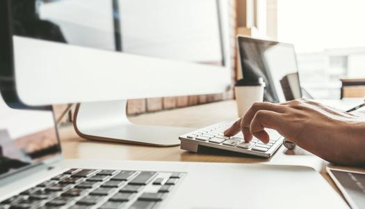 Person typing at a computer.