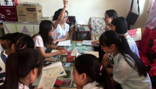 Eight students working on a project together at a table.