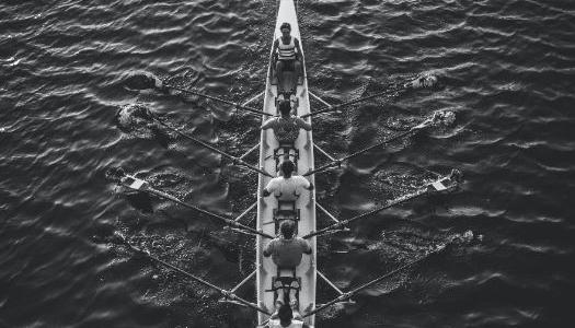 A boat with rowers in it.