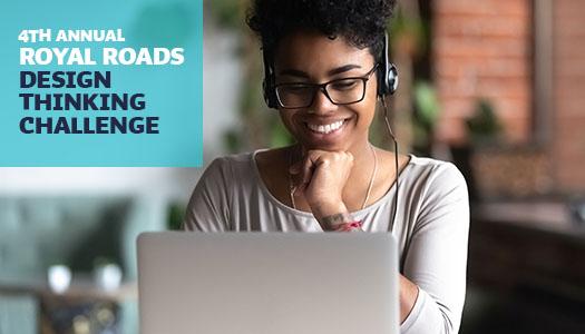 Student wearing a headset and looking at computer.