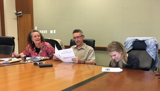 Student-and-faculty-seated-a-wooden-board-table
