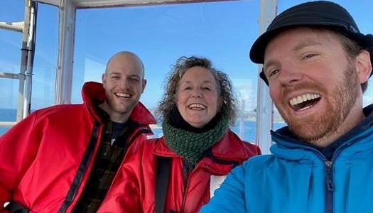 Three-people-on-Pearson-College's-boat-Second-Nature