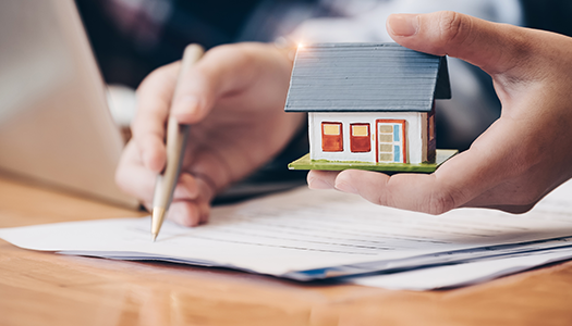 person signing real estate papers