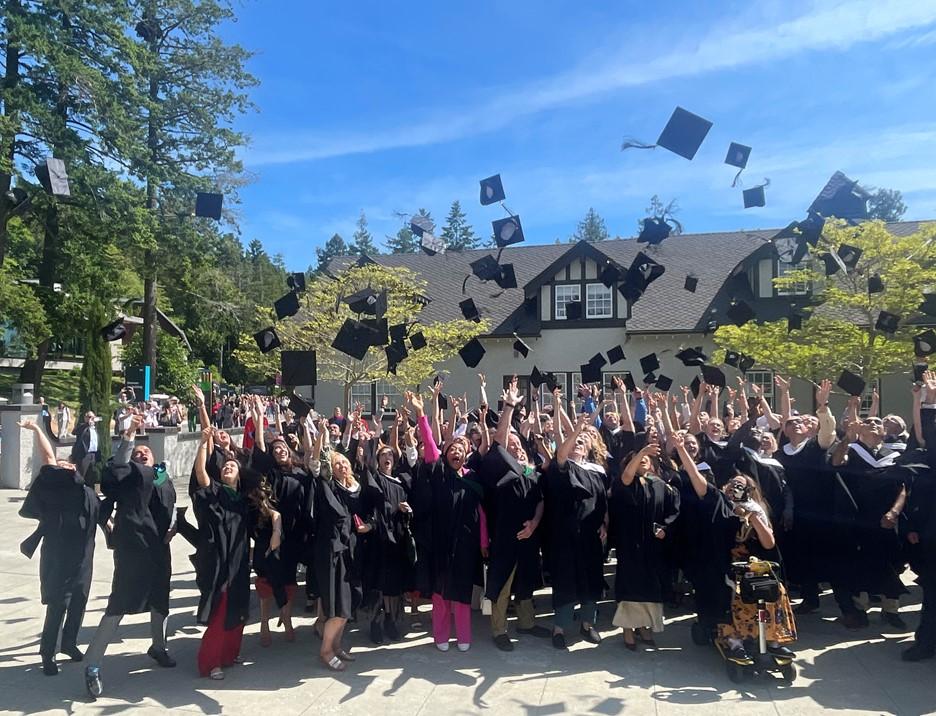 Graduates throwing caps in sky