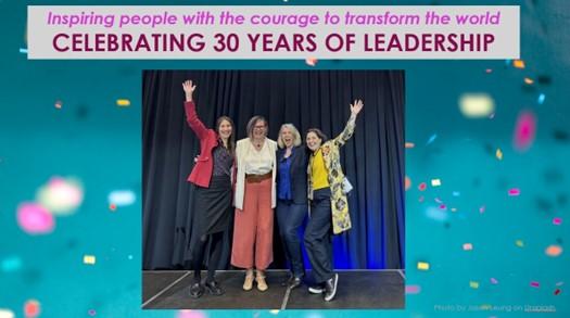 Four smiling women celebrating