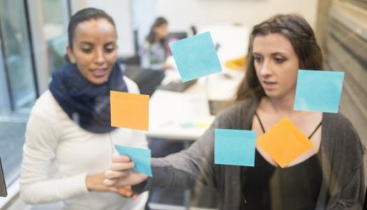 Students-looking-at-window-of-sticky-notes