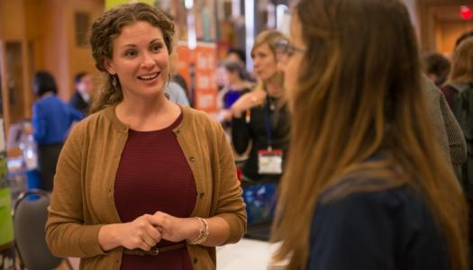 A propsective employer is talking to a student at the Career Development Day event.