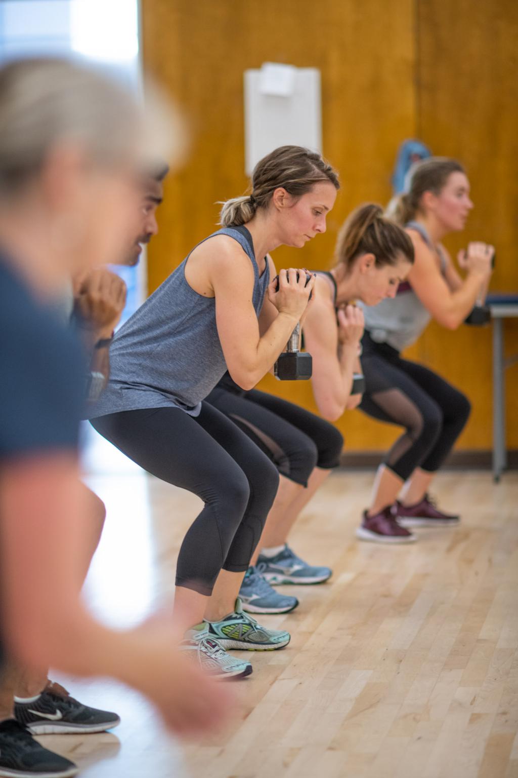 Group of students with weights in fitness class