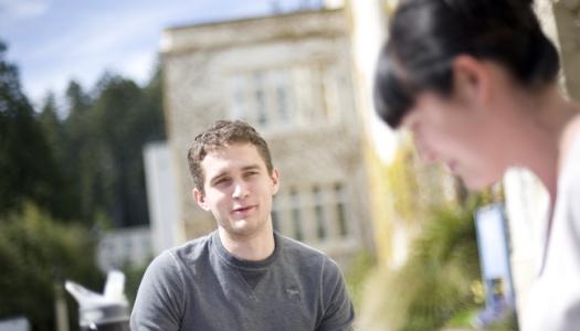 two-people-standing-outdoors-on-campus
