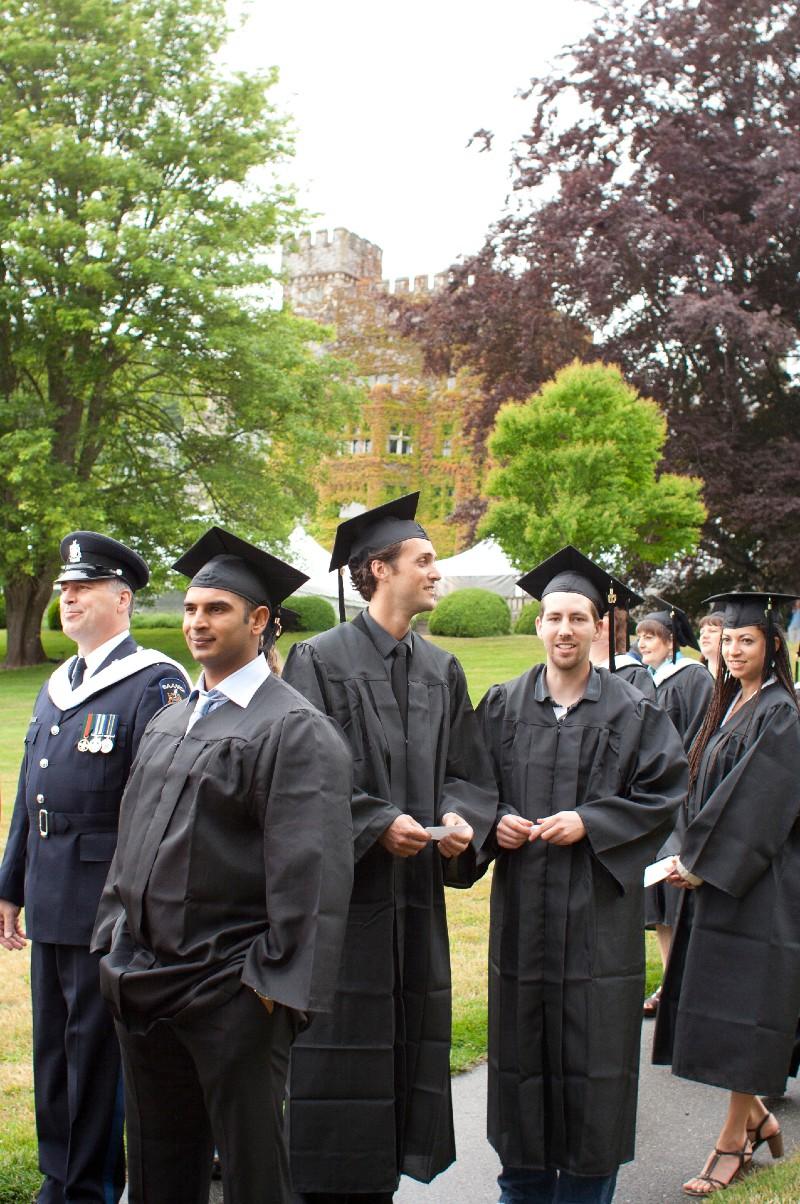 Students-standing-in-Convocation-caps-and-gowns