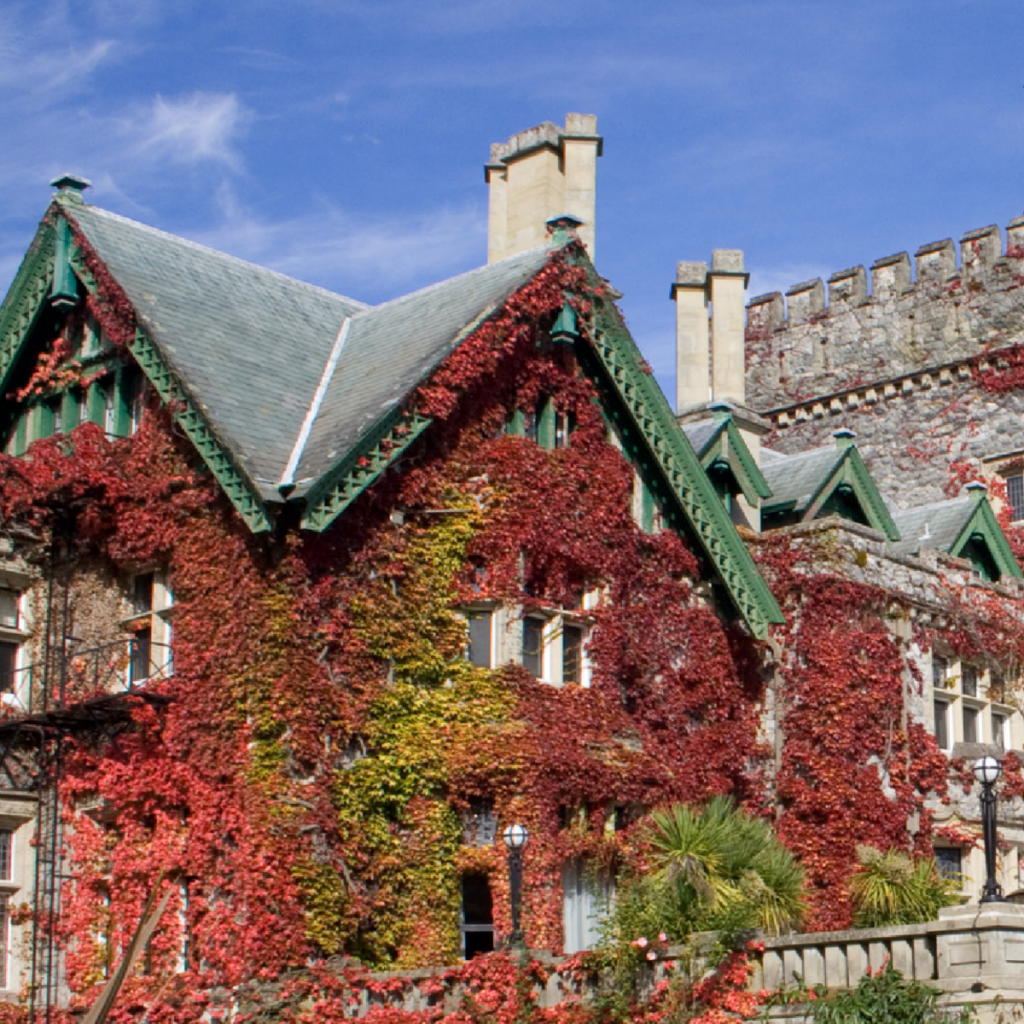 View of Hatley Castle with red and green foliage.