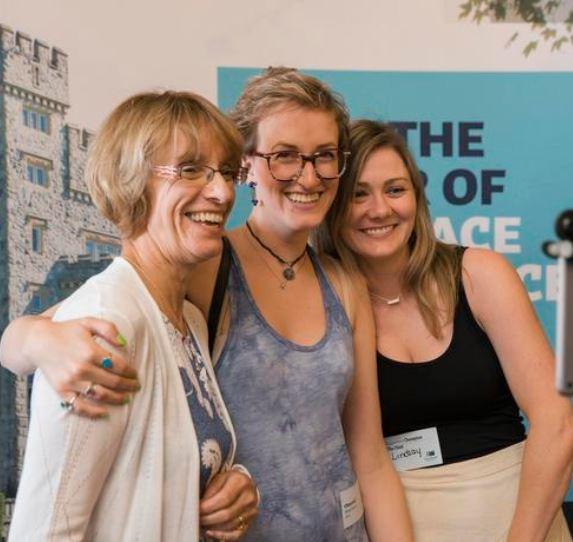 Three alumni smiling together