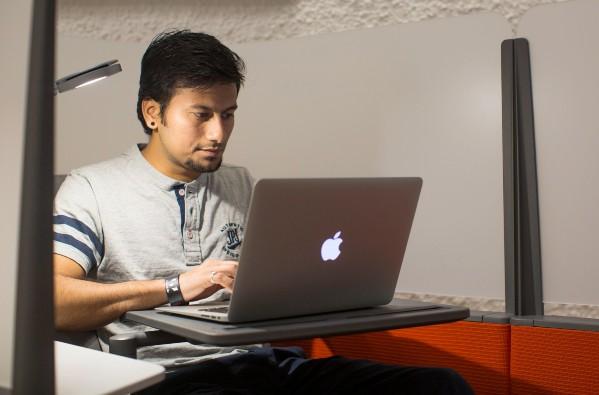 Student using a laptop while sitting on a couch
