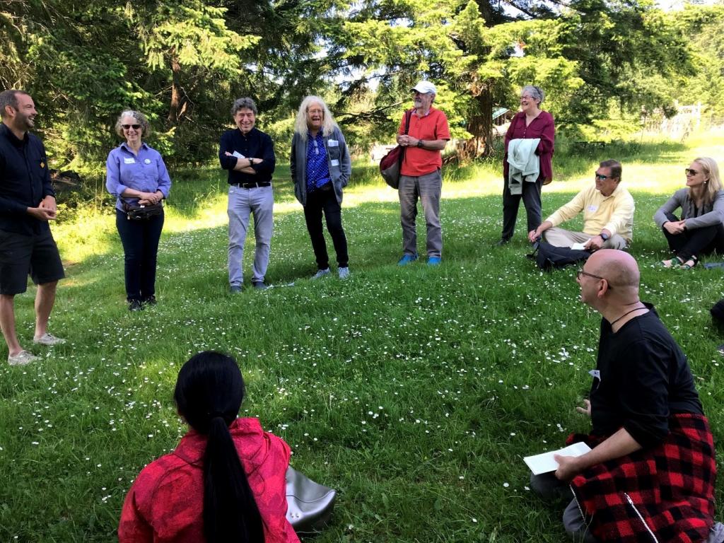 A group listens to elected official Scott Colbourne at left of image. Second from left facing the camera is chapter author Alice MacGillivray; third from left is editor and author Rich Appelbaum; fifth from left is editor and author Fred Steier. Photo by David Blake Willis.