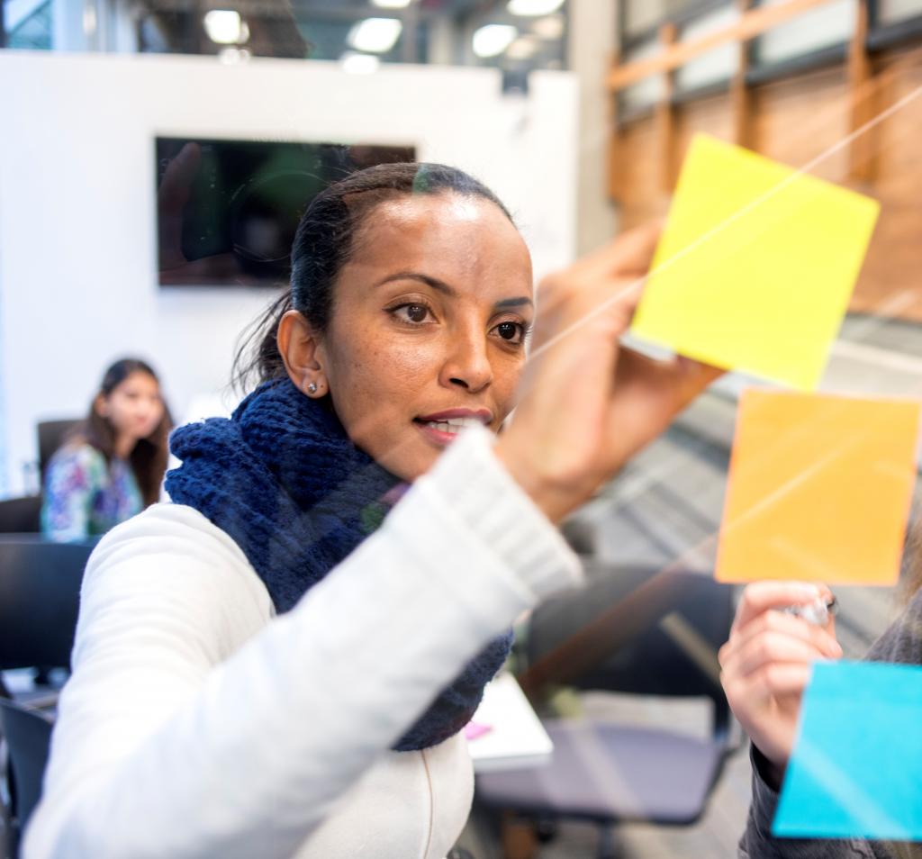 student with notes on glass