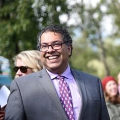 Naheed Nenshi smiles in a crowd of people