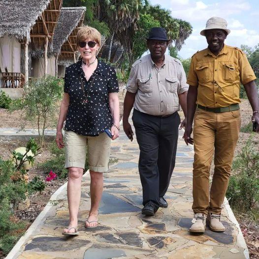 Three people walking in Tsavo National Park.