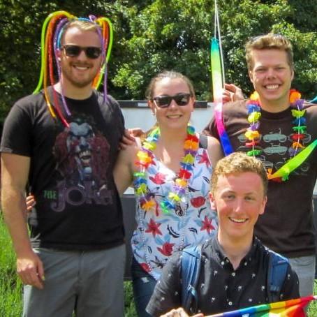 A group of four students in colourful pride garb. 