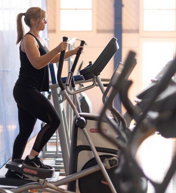 A person uses an elliptical at the Royal Roads University gym