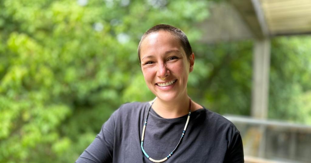 Erynne Gilpin smiles in front of a natural background.
