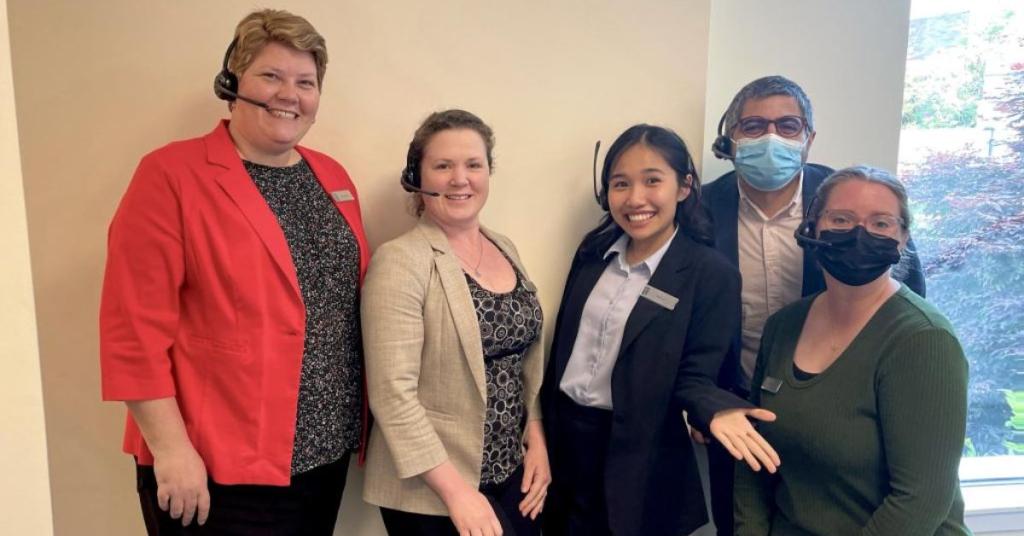 Kayla Ngo (third from left) poses with the Reservations team in their office at Inn at Laurel Point.