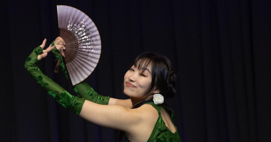 A woman performs a Chinese fan dance