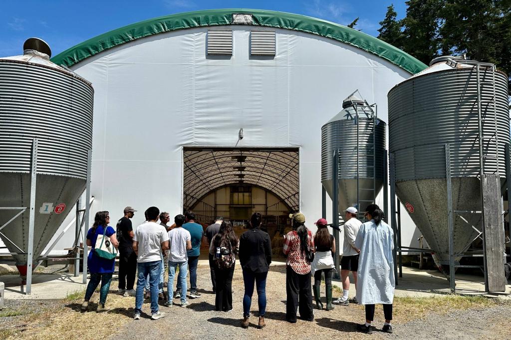 Students prepare to enter a large pig barn