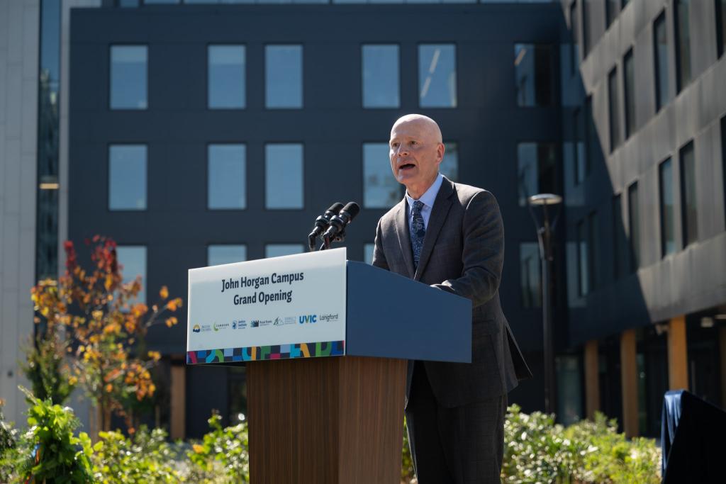 President Steenkamp speaks at a podium at opening of new RRU Langford