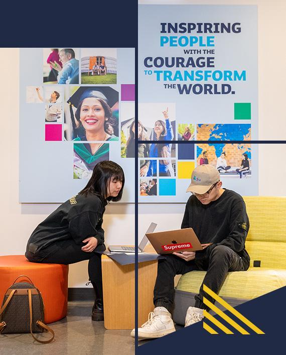 two students sit next to each other in an open study area at Royal Roads University